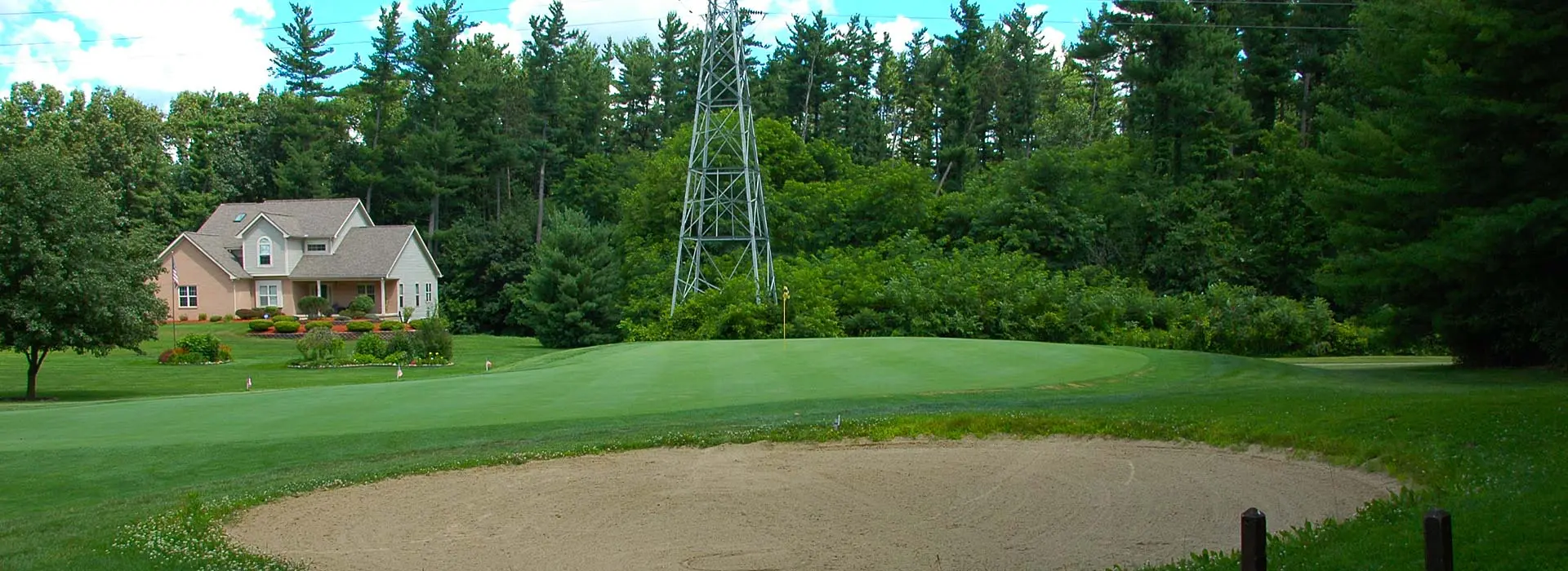 Image of golf ball on tee on grass.